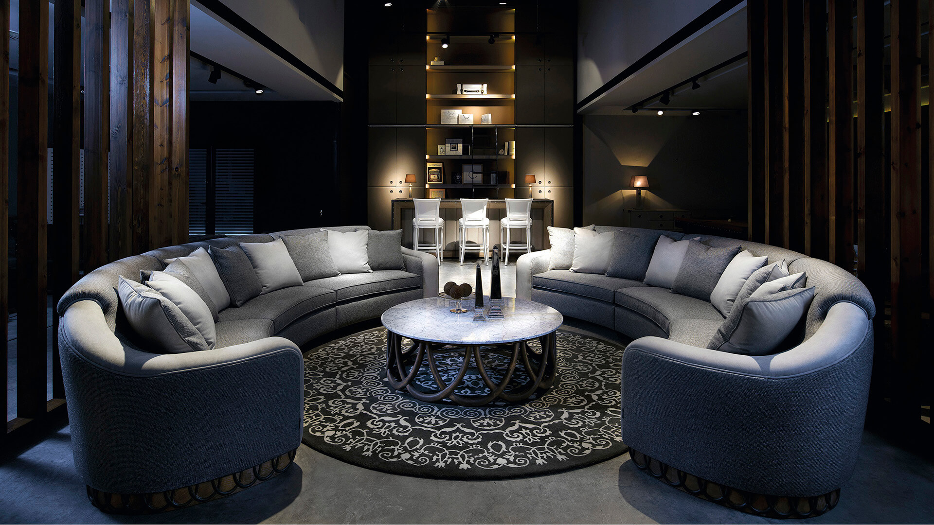 Elegant contemporary lounge with curved sofa and marble coffee table.