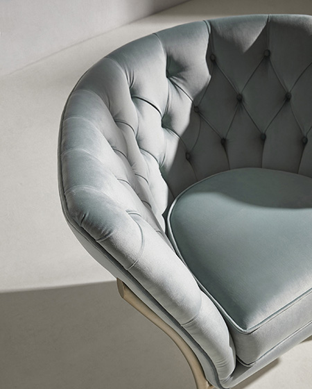 Detail of the handcrafted deep-buttoned upholstery of the Flute armchair, an icon of the Evolution collection.