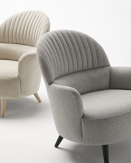 Detail of the backrest of the Cricket armchair with handcrafted upholstery combined with a modern design.