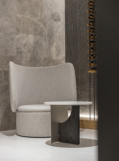 Original décor for a modern corner consisting of a designer armchair and a side table made of high quality materials.
