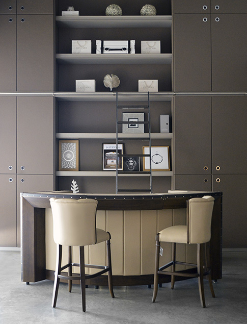 Contemporary bar area consisting of a sophisticated curved counter and comfortable high stools.