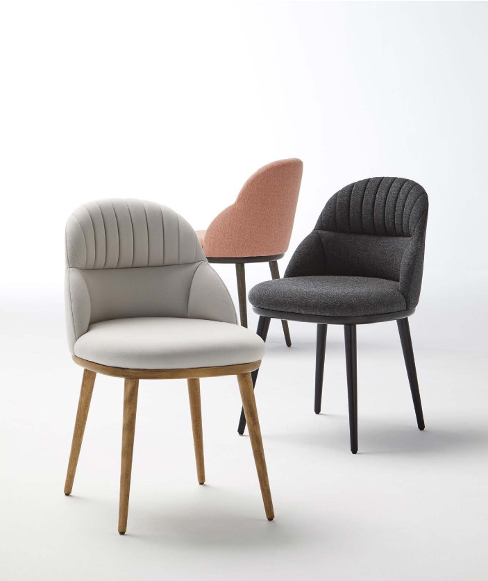 Three Cricket chairs with wooden legs and upholstered in fabric and leather.