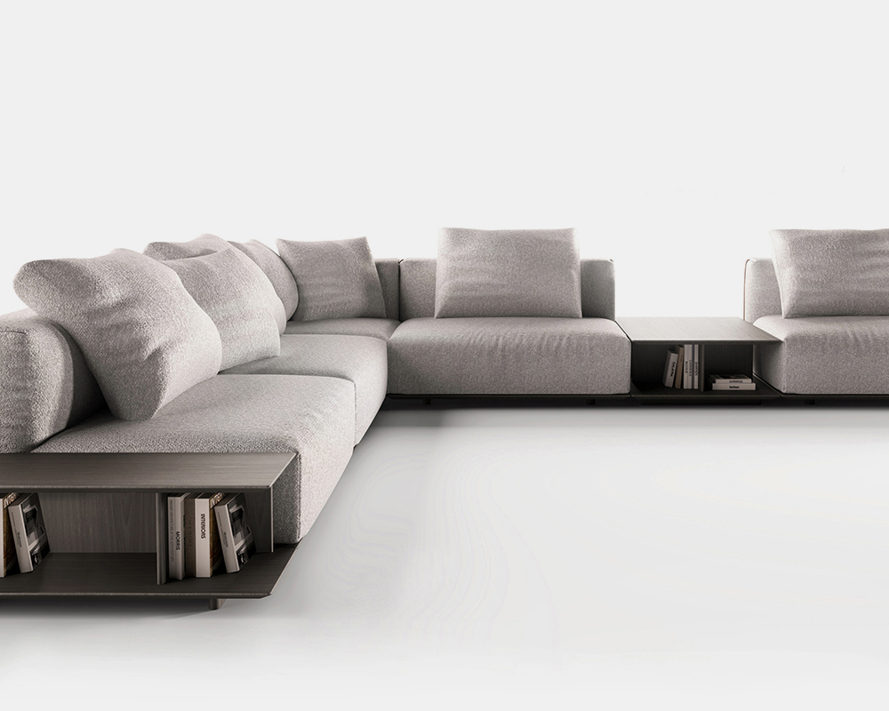 Composición de sofá modular Capri con mesa auxiliar integrada, con un tapizado gris perla.