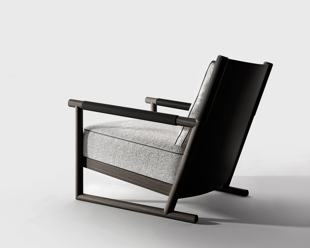 Detalle del sillón Ischia con acabados en piel marrón y fresno negro, con un suave tapizado gris.